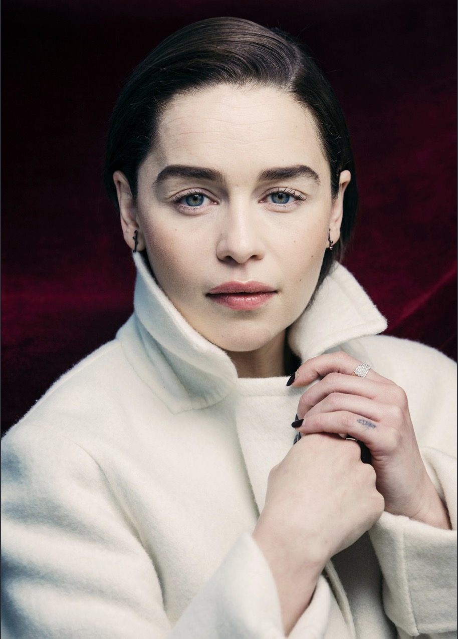 Emilia Clarke in an editorial portrait against a burgundy velvet backdrop
